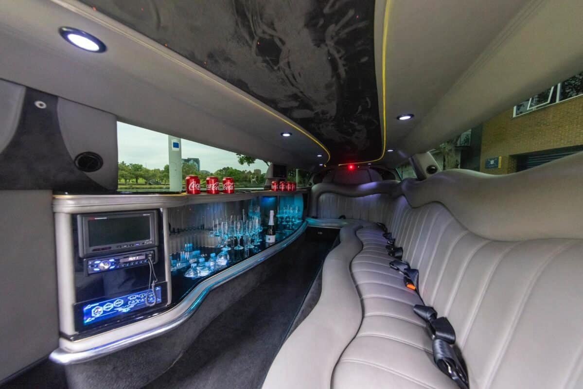 Luxury party bus interior featuring a bar, comfortable seating, and ambient lighting for events and.
