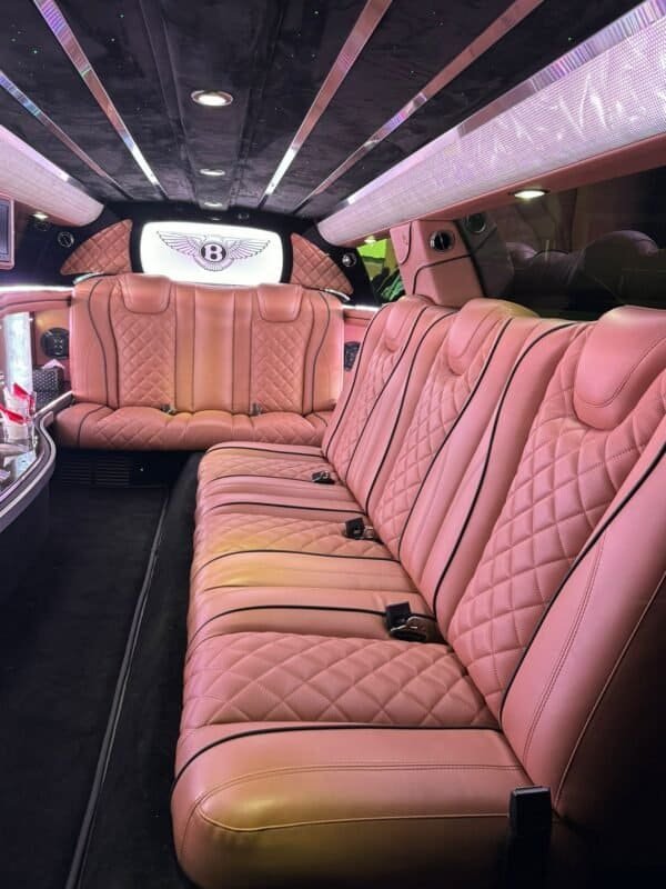 Elegant pink leather car interior with spacious seating and premium details.