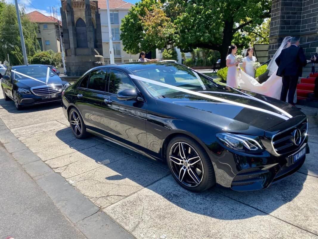Luxury black Mercedes-Benz sedan for special events and weddings.